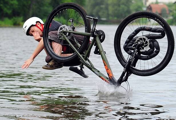 ITAR-TASS: IVANOVO, RUSSIA. AUGUST 5, 2013. Competitors jump into the water off a ramp in Fun Jumping, a bike jumping event in the city of Ivanovo.  RE1245F1