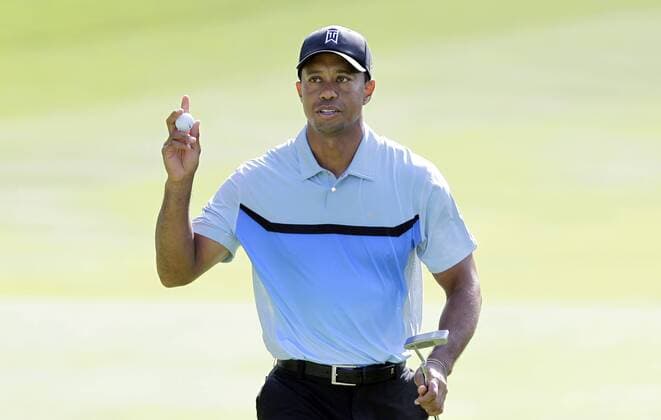 Tiger Woods reacts after making a birdie putt on the 13th hole in the first round of the PGA Golf Herren Championship at Oak Hill Country Club in Rochester, New York on August 8, 2013.  NYP20130808115