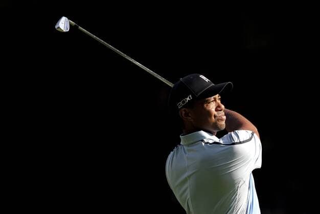 Tiger Woods hits his approach shot to the 12th green in the first round of the PGA Golf Herren Championship at Oak Hill Country Club in Rochester, New York on August 8, 2013.  NYP20130808118