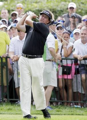 Phil Mickelson hits his tee shot on the the 10th hole in the first round of the PGA Golf Herren Championship at Oak Hill Country Club in Rochester, New York on August 8, 2013.  NYP20130808172