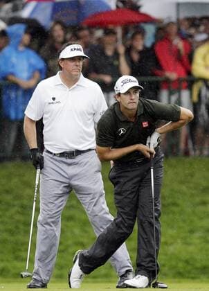 Phil Mickelson watches Adam Scott s tee ball on the 14th hole in the second round of the PGA Golf Herren Championship at Oak Hill Country Club in Rochester, New York on August 9, 2013.  NYP20130809117