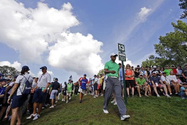 Tiger Woods walks to the 14th hole tee box in the second round of the PGA Golf Herren Championship at Oak Hill Country Club in Rochester, New York on August 9, 2013.  NYP20130809151