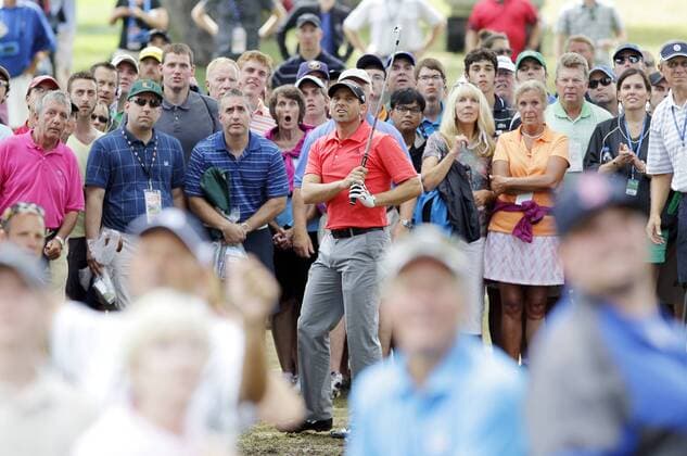 Fans surrounding Sergio Garcia react after he hits a shot out of the 9th hole rough in the second round of the PGA Golf Herren Championship at Oak Hill Country Club in Rochester, New York on August 9, 2013.  NYP20130809159