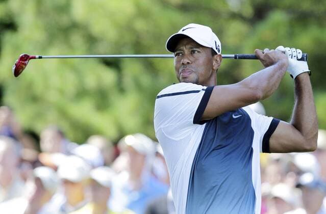 Tiger Woods hits a tee shot on the 10th hole in the third round of the PGA Golf Herren Championship at Oak Hill Country Club in Rochester, New York on August 10, 2013.  NYP20130810108