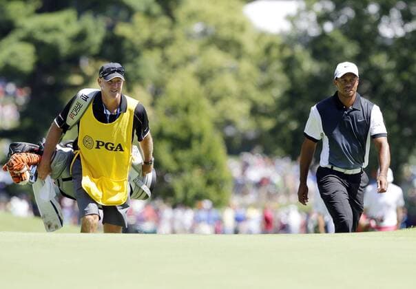 Tiger Woods and Caddie Joe LaCava walk to the 9th green in the third round of the PGA Golf Herren Championship at Oak Hill Country Club in Rochester, New York on August 10, 2013.  NYP20130810110