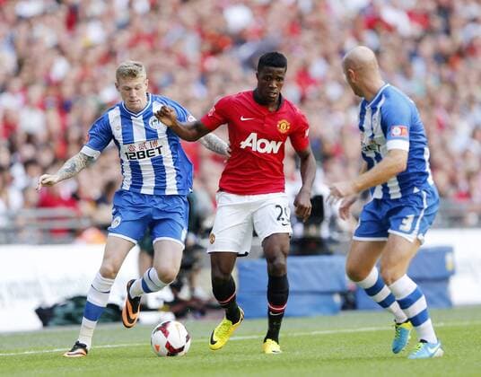 Manchester United s Wilfred Zaha tussles with Wigan s James McClean Manchester United v Wigan Athletic - FA Community Shield - Wembley - London - England -11 08 2013 - Pic David Klein Sportimage EDITORIAL USE ONLY. No use with unauthorised audio, video, data, fixture lists, club league logos or live services. Online in-match use limited to 120 images, no video emulation. No use in betting, games or single club league player publications.