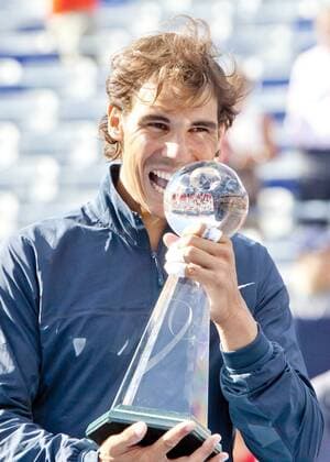 Aug. 11, 2013 - Montreal, Quebec, CAN - Rafael Nadal puts his signature bite on the Rogers Cup trophy after winning the men s singles finals on championship Sunday in straight sets, 6-2, 6-2. Tennis 2013 - Rogers Cup Finals- AUG 11 - ZUMAs30