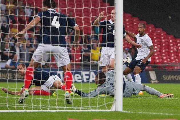 Theo Walcott of England watches on his strike finds the back of the net to level the scores at 1-1 - England v Scotland - International Friendly - Wembley Stadium - London - 13 08 2013 Pic Philip Oldham Sportimage EDITORIAL USE ONLY. No use with unauthorised audio, video, data, fixture lists, club league logos or live services. Online in-match use limited to 120 images, no video emulation. No use in betting, games or single club league player publications.