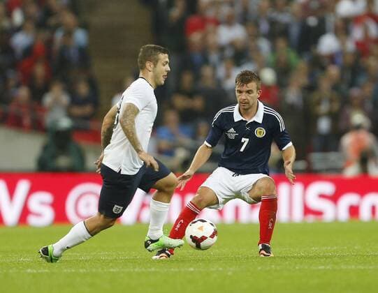 England s Jack Wilshere tussles with Scotland s James Morrison England v Scotland - International Friendly - Wembley - London - England -14 08 2013 - Pic DavidxKlein Sportimage EDITORIAL USE ONLY. No use with unauthorised audio, video, data, fixture lists, club league logos or live services. Online in-match use limited to 120 images, no video emulation. No use in betting, games or single club league player publications.