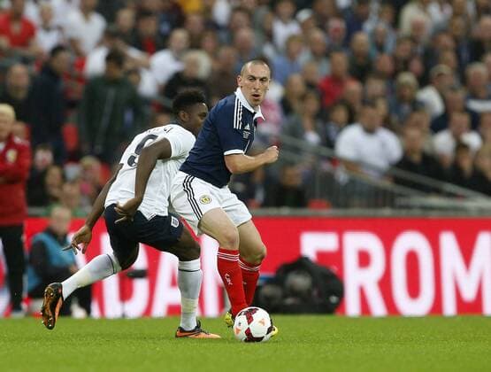 England s Danny Welbeck gets tackled by Scotland s Scott Brown England v Scotland - International Friendly - Wembley - London - England -14 08 2013 - Pic DavidxKlein Sportimage EDITORIAL USE ONLY. No use with unauthorised audio, video, data, fixture lists, club league logos or live services. Online in-match use limited to 120 images, no video emulation. No use in betting, games or single club league player publications.