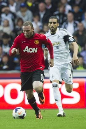 Football - 2013 2014 Premier League - Swansea City vs. Manchester United (ManU) wayne rooney attacks, chased by chico flores, at Liberty Stadium.