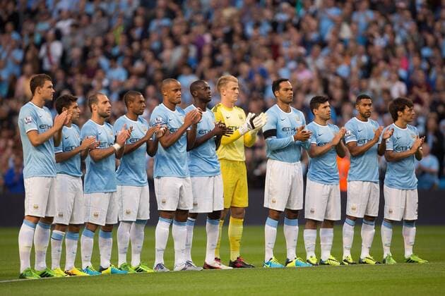 Manchester City take part in a minutes applause for the late Bert Trautmann - Manchester City - Premier League - Etihad Stadium - Manchester - 19 08 2013 Pic Philip Oldham Sportimage EDITORIAL USE ONLY. No use with unauthorised audio, video, data, fixture lists, club league logos or live services. Online in-match use limited to 120 images, no video emulation. No use in betting, games or single club league player publications.