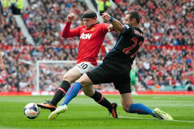 Wayne Rooney of Manchester United and Damien Delaney of Crystal Palace - Manchester United ManU vs. Crystal Palace - Premier League - Old Trafford - Manchester - 14 09 2013 EDITORIAL USE ONLY. No use with unauthorised audio, video, data, fixture lists, club league logos or live services. Online in-match use limited to 120 images, no video emulation. No use in betting, games or single club league player publications.