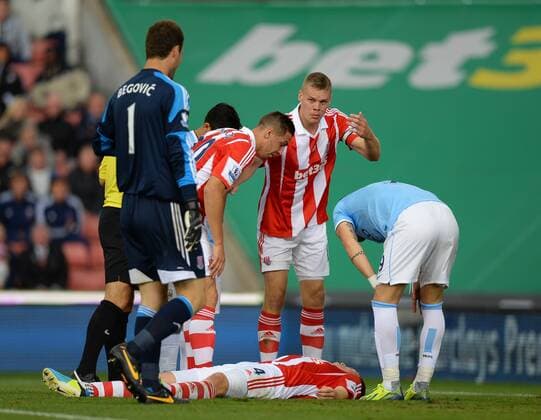 Robert Huth of Stoke City lies on the ground and Ryan Shawcross of Stoke City shouts for assistance - Barclays Premier League - Stoke City vs Manchester City - Britannia Stadium - Stoke on Trent - 14 09 13 - Picture Simon Bellis Sportimage EDITORIAL USE ONLY. No use with unauthorised audio, video, data, fixture lists, club league logos or live services. Online in-match use limited to 120 images, no video emulation. No use in betting, games or single club league player publications.