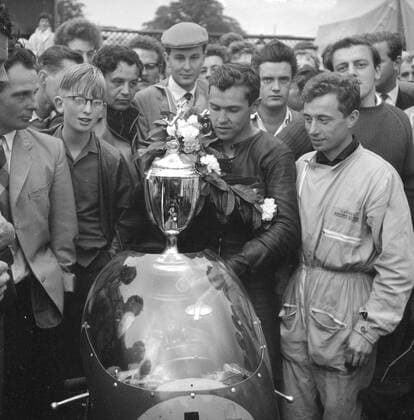 Mallory park, Leicester: Rhodesian Motor-cycling ace, Gary Hocking with the famous Italian MV Augusta Motorcycle, Laurels and cup with his Italian motor-cycle mechanic in the pits at Mallory Park (24th September) after he had won the race of the year at an average speed of 87.72 M.P.H.. The senior champion won the Â£1,000 first prize beating Britain s Mike Hailwood (499 Norton) into second place. 25 September1961  UnitedArchives00933800