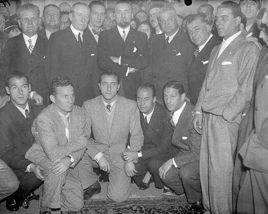 Signor Grandi ( Italian Ambassador in London ) receives the Italian footballers who are to meet England at Highbury tomorrow at the Italian Embassy - Marchase Marconi was also present - photo shows Signor Grandi ( centre ) with Marchese Marconi and the Italian team at the Embassy in London November 13th 1934  UnitedArchives00951620