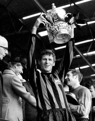 26th April 1969: The FA cup final at Wembley. Manchester City (1) versus Leicester City (0) Photo shows: Tony Book (aged 34), holds aloft the FA cup trophy, as Princess Anne shakes hands with City goalkeeper, Harry Dowd.  UnitedArchives01009473