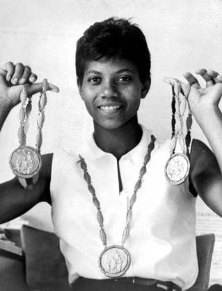 Rome: America s Wilma Rudolph holds up her three gold medals she won during the 1960 Olympic Games for winning the 200 metres, 100 meters and 4 x 100 meters Relay Event. 9 September 1960  UnitedArchives01015619