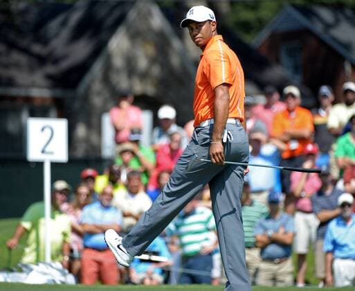 Tiger Woods reacts as he putts for birdie on No. 2 but misses during the first round of the PGA Golf Herren Tour Championship on September 19, 2013 at East Lake Golf Club in Atlanta. Woods made a par on the hole.  AJP2013091911
