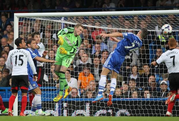 Fulham s David Stockdale watches as Chelsea s Gary Cahill misses the ball Chelsea FC London v FC Fulham - Barclays Premier League- Stamford Bridge - London - England -21 09 2013 - EDITORIAL USE ONLY. No use with unauthorised audio, video, data, fixture lists, club league logos or live services. Online in-match use limited to 120 images, no video emulation. No use in betting, games or single club league player publications.