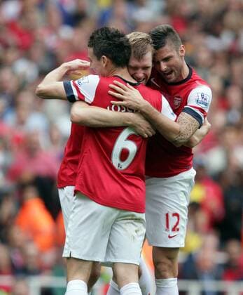 Arsenal v Stoke City . . London, UK . . 22.09.2013 Laurent Koscielny (A) and Olivier Giroud (A) congratulate Per Mertesacker (A) after scoring a goal. 2-1 