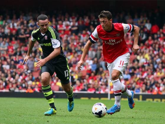 Arsenal v Stoke City . . London, UK . . 22.09.2013 Marc Wilson (SC) Mesut Ozil (A) 