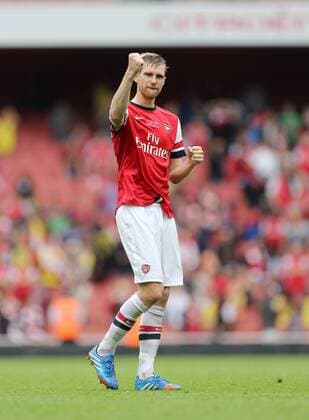 Arsenal s Per Mertesacker celebrates at the final whistle Arsenal v Stoke - Barclays Premier League- Emirates Stadium - London - England -22 09 2013 - EDITORIAL USE ONLY. No use with unauthorised audio, video, data, fixture lists, club league logos or live services. Online in-match use limited to 120 images, no video emulation. No use in betting, games or single club league player publications.
