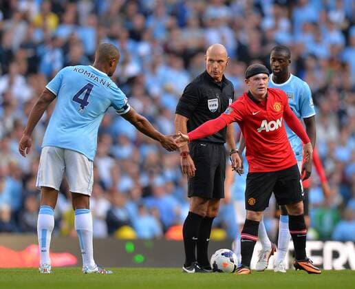 Vincent Kompany of Manchester City shakes hands with Wayne Rooney of Manchester United- Barclays Premier League - Manchester City vs Manchester Utd - Etihad Stadium - Manchester - 22 09 13 - EDITORIAL USE ONLY. No use with unauthorised audio, video, data, fixture lists, club league logos or live services. Online in-match use limited to 120 images, no video emulation. No use in betting, games or single club league player publications.