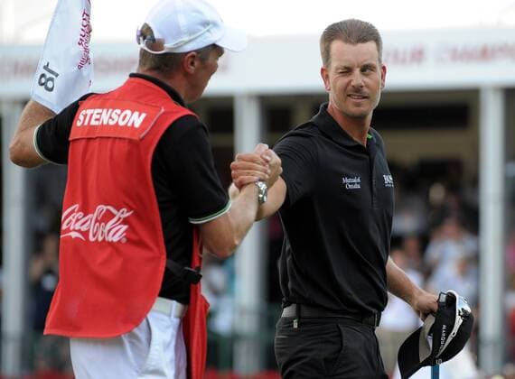 Tournament winner Henrik Stenson (R) winks at his caddie after putting out on No. 18 during the final round of the PGA Golf Herren Tour Championship on September 22, 2013 at East Lake Golf Club in Atlanta. Stenson also won the FedEx Cup playoff with a 13-under par score for a $10 million payout bonus.  AJP2013092217