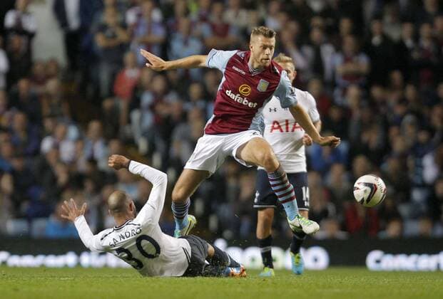 Nathan Baker of Aston Villa hurdles a challenge from Sandro of Tottenham - Football - Capital One Cup - Aston Villa vs Tottenham Hotspur - Villa Park Birmingham - Season 2013-2014 - September 24th 2013 - Photograph Malcolm Couzens Sportimage EDITORIAL USE ONLY. No use with unauthorised audio, video, data, fixture lists, club league logos or live services. Online in-match use limited to 120 images, no video emulation. No use in betting, games or single club league player publications.