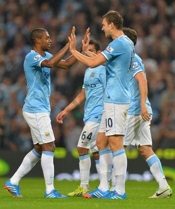 Goalscorer Edin Dzeko of Manchester City celebrates scoring the first with provider Fernandinho of Manchester City - Capital One Cup - Third Round - Manchester City vs Wigan Athletic - Etihad Stadium - Manchester - 24 09 13 - Picture Simon Bellis Sportimage EDITORIAL USE ONLY. No use with unauthorised audio, video, data, fixture lists, club league logos or live services. Online in-match use limited to 120 images, no video emulation. No use in betting, games or single club league player publications.