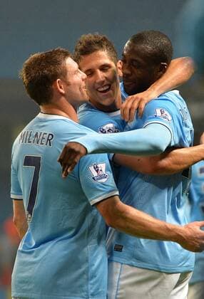 Yaya Toure of Manchester City celebrates with Stevan Jovetic of Manchester City and James Milner of Manchester City - Capital One Cup - Third Round - Manchester City vs Wigan Athletic - Etihad Stadium - Manchester - 24 09 13 - Picture Simon Bellis Sportimage EDITORIAL USE ONLY. No use with unauthorised audio, video, data, fixture lists, club league logos or live services. Online in-match use limited to 120 images, no video emulation. No use in betting, games or single club league player publications.
