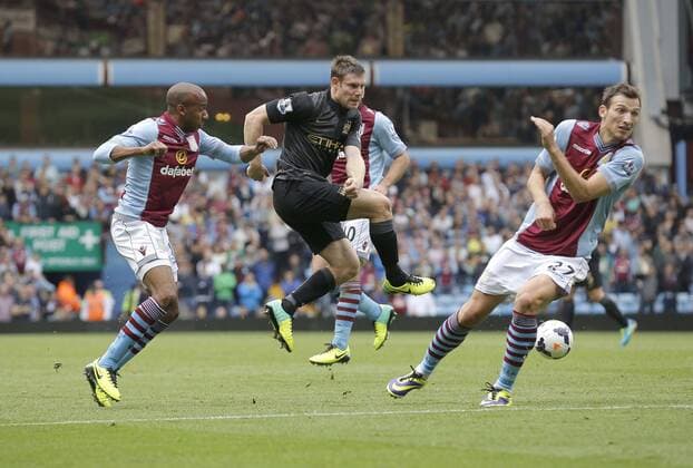 James Milner of Manchester City gets between Fabian Delph and Libor Kozak to fire a shot at goal - Football - Barclays Premier League - Aston Villa vs Manchester City - Villa Park Birmingham - Season 2013-2014 - September 28th 2013 - Photograph Malcolm Couzens Sportimage EDITORIAL USE ONLY. No use with unauthorised audio, video, data, fixture lists, club league logos or live services. Online in-match use limited to 120 images, no video emulation. No use in betting, games or single club league player publications.