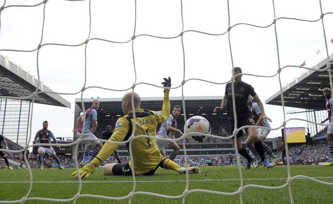 Yaya Toure of Manchester City sees his deflected shot go past Aston Villa goalkeeper Brad Guzan for City s first goal - Football - Barclays Premier League - Aston Villa vs Manchester City - Villa Park Birmingham - Season 2013-2014 - September 28th 2013 - Photograph Malcolm Couzens Sportimage EDITORIAL USE ONLY. No use with unauthorised audio, video, data, fixture lists, club league logos or live services. Online in-match use limited to 120 images, no video emulation. No use in betting, games or single club league player publications.