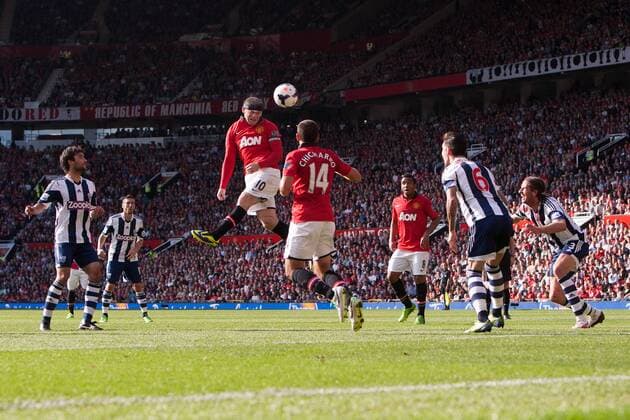 Wayne Rooney of Manchester United sends a header goalwards - Manchester United vs. West Bromwich Albion - Barclay s Premier League - Old Trafford - Manchester - 28 09 2013 Pic Philip Oldham Sportimage EDITORIAL USE ONLY. No use with unauthorised audio, video, data, fixture lists, club league logos or live services. Online in-match use limited to 120 images, no video emulation. No use in betting, games or single club league player publications.