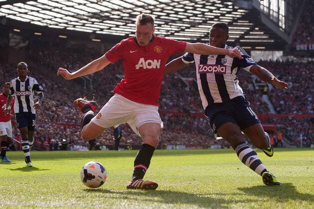 Phil Jones of Manchester United and West Brom s Victor Anichebe in action - Manchester United vs. West Bromwich Albion - Barclay s Premier League - Old Trafford - Manchester - 28 09 2013 Pic Philip Oldham Sportimage EDITORIAL USE ONLY. No use with unauthorised audio, video, data, fixture lists, club league logos or live services. Online in-match use limited to 120 images, no video emulation. No use in betting, games or single club league player publications.
