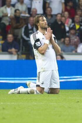 Football - 2013 2014 Premier League - Swansea City vs. Arsenal michu with hands in prayer position at the Liberty Stadium. COLORSPORT WINSTON BYNORTH 