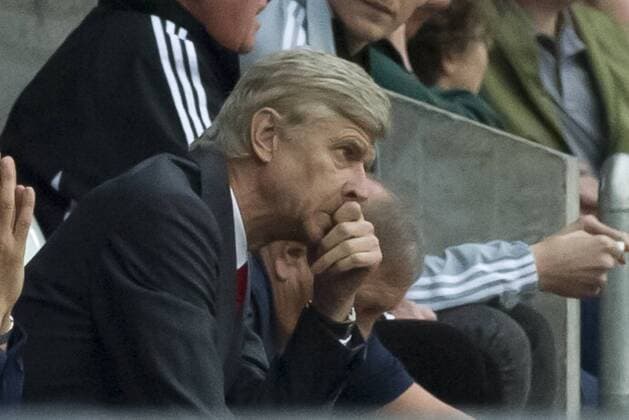 Football - 2013 2014 Premier League - Swansea City vs. Arsenal arsenE Wenger looks pensive at the Liberty Stadium.COLORSPORT WINSTON BYNORTH
