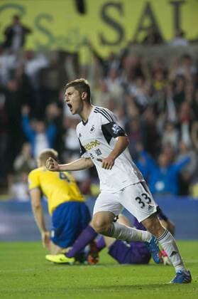 Football - 2013 2014 Premier League - Swansea City vs. Arsenal ben davies celebrates swansea s goal at the Liberty Stadium. COLORSPORT WINSTON BYNORTH