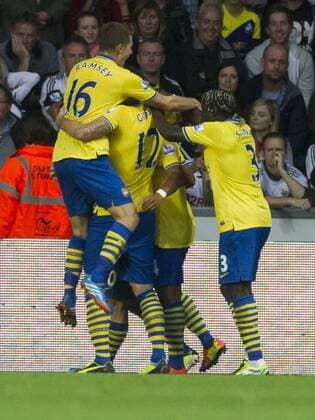 Football - 2013 2014 Premier League - Swansea City vs. Arsenal arsenal mob serge gnabry after he scores their 1st goal at the Liberty Stadium. COLORSPORT WINSTON BYNORTH