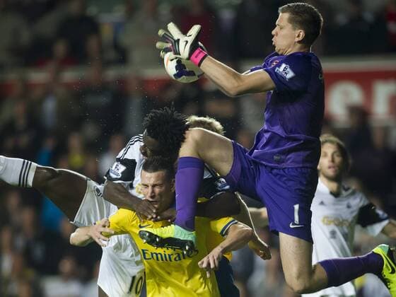 Football - 2013 2014 Premier League - Swansea City vs. Arsenal wojciech szczesny leaps to save from bony at the Liberty Stadium. COLORSPORT WINSTON BYNORTH