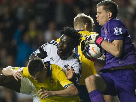 Football - 2013 2014 Premier League - Swansea City vs. Arsenal wojciech szczesny leaps to save from bony at the Liberty Stadium. COLORSPORT WINSTON BYNORTH