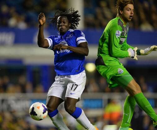 Romelu Lukaku of Everton beats Tim Krul of Newcastle United to the ball to score his second of the night - Barclays Premier League - Everton vs Newcastle Utd - Goodison Park Stadium - Liverpool - England - 30 09 13 - Picture Simon Bellis Sportimage EDITORIAL USE ONLY. No use with unauthorised audio, video, data, fixture lists, club league logos or live services. Online in-match use limited to 120 images, no video emulation. No use in betting, games or single club league player publications.