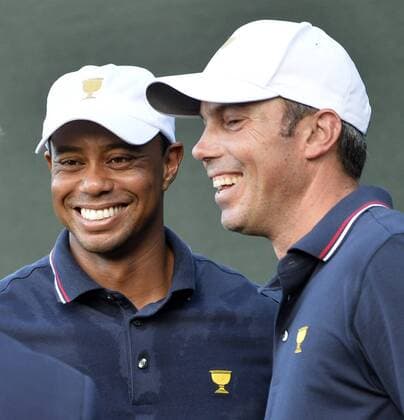 United States Team members Tiger Woods (L) and Matt Kuchar smile after their 4 up win against International Team member Angel Cabrera of Argentina and Marc Leishman of Australia during the fourball matches at the 2013 Presidents Cup at Muirfield Village Golf Club in Dublin, Ohio on October 3, 2013. After Thursday s matches, the United States leads 3.5 to 2.5 points.  BKX2013100362