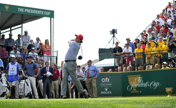 United States Team member Phil Mickelson tees off on the first hole during the second round foursome competition against the International Team at the 2013 Presidents Cup at Muirfield Village Golf Club in Dublin, Ohio on October 4, 2013.  BKX2013100408