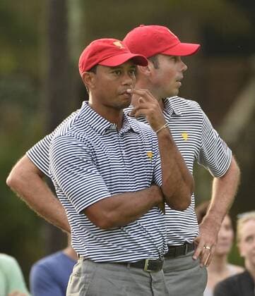 United States Team members Tiger Woods and Matt Kuchar stand on the seventh green during the second round foursome competition at the 2013 Presidents Cup at Muirfield Village Golf Club in Dublin, Ohio on October 4, 2013.  BKX2013100449