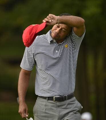 United States Team member Tiger Woods stands on the eighth green during the second round foursome competition against the International Team at the 2013 Presidents Cup at Muirfield Village Golf Club in Dublin, Ohio on October 4, 2013.  BKX2013100455