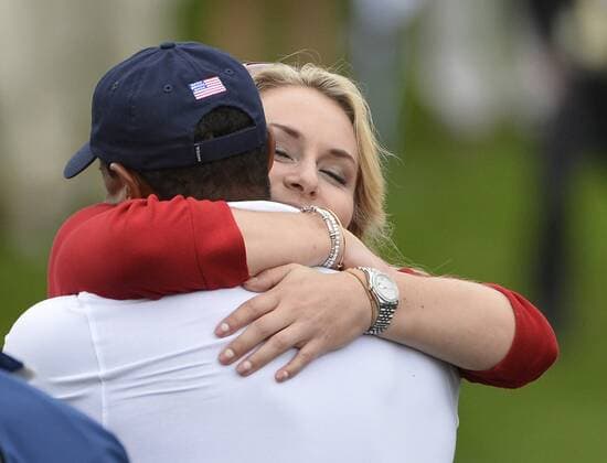 United States Team member Tiger Woods gets a hug from girlfriend Lindsey Vonn on the 18th green after the fifth round singles competition at the 2013 Presidents Cup at Muirfield Village Golf Club in Dublin, Ohio on October 6, 2013. The United States defeated the International Team 18.5 to 15.5 to retain the Presidents Cup.  BKX2013100620
