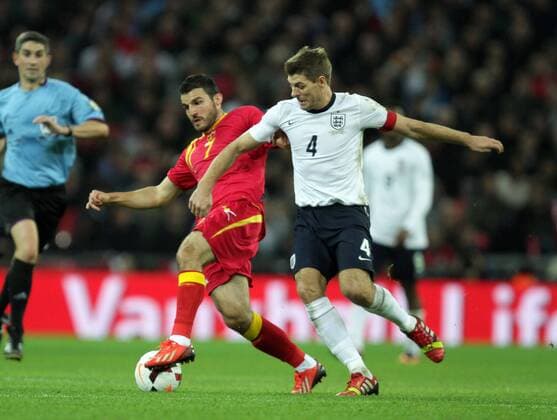 England v Montenegro - World Cup Qualifier . . Wembley, London, UK . . 11.10.2013 Simon Vukcevic (M) Steven Gerrard (E)