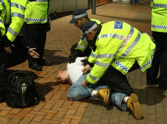 Poland - World Cup Qualifier . . Wembley, London . . 15.10.2013 A Polish fan is restrained by police outside Wembley Stadium.